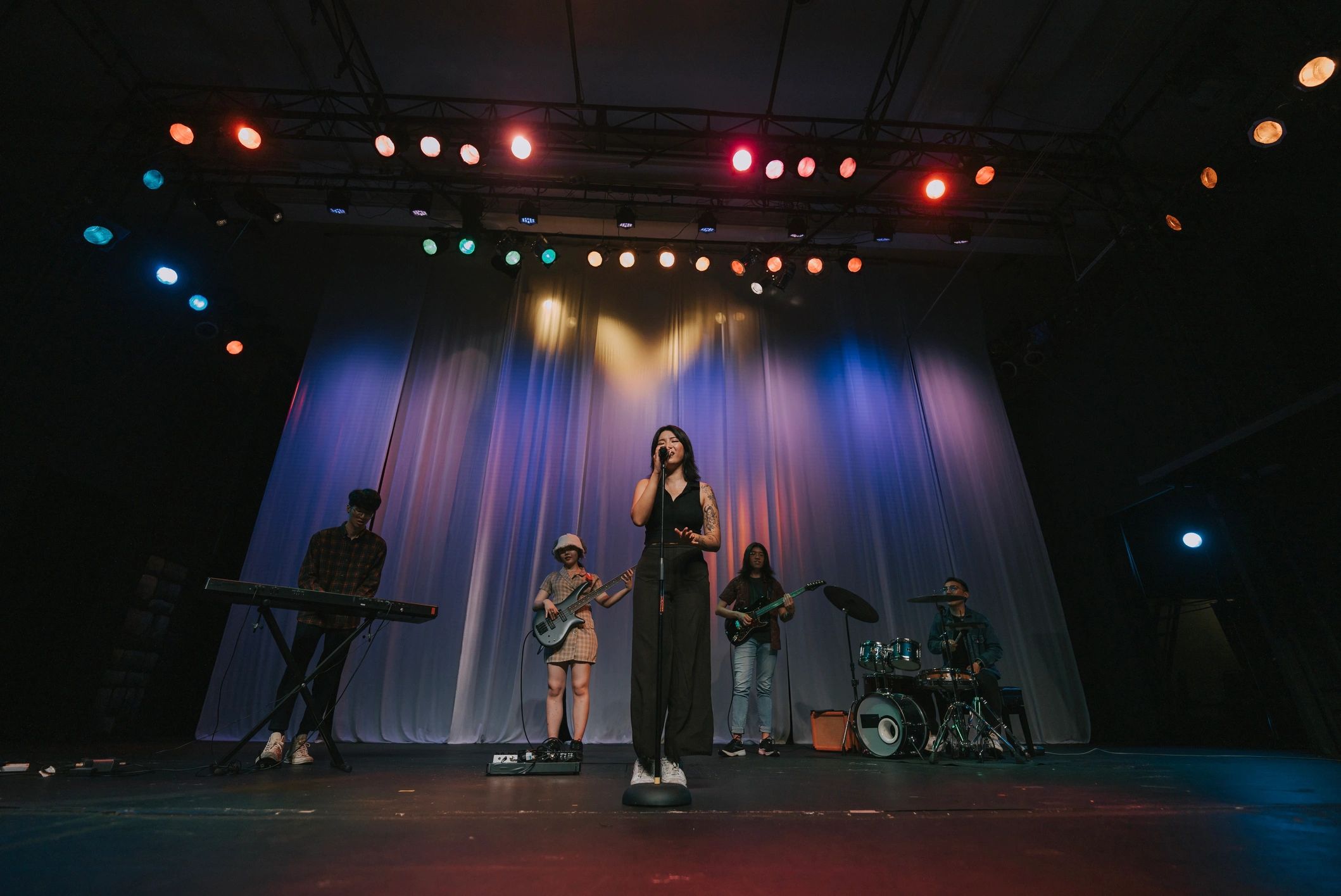 Live band performing on stage for a music audience
