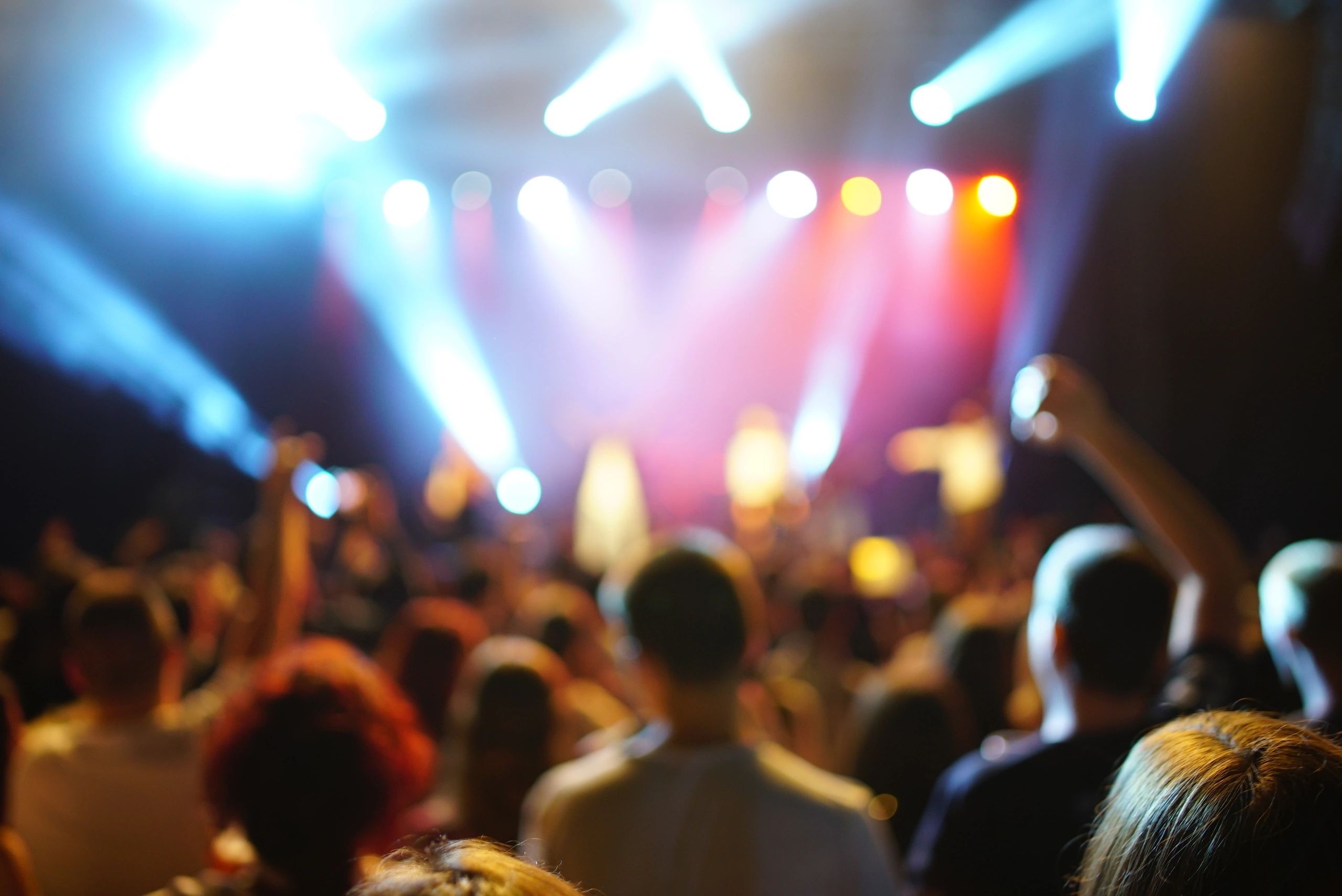 Concert crowd enjoying a brightly lit live show